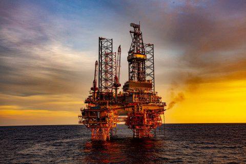 Oil Rig in Ocean at Sunset